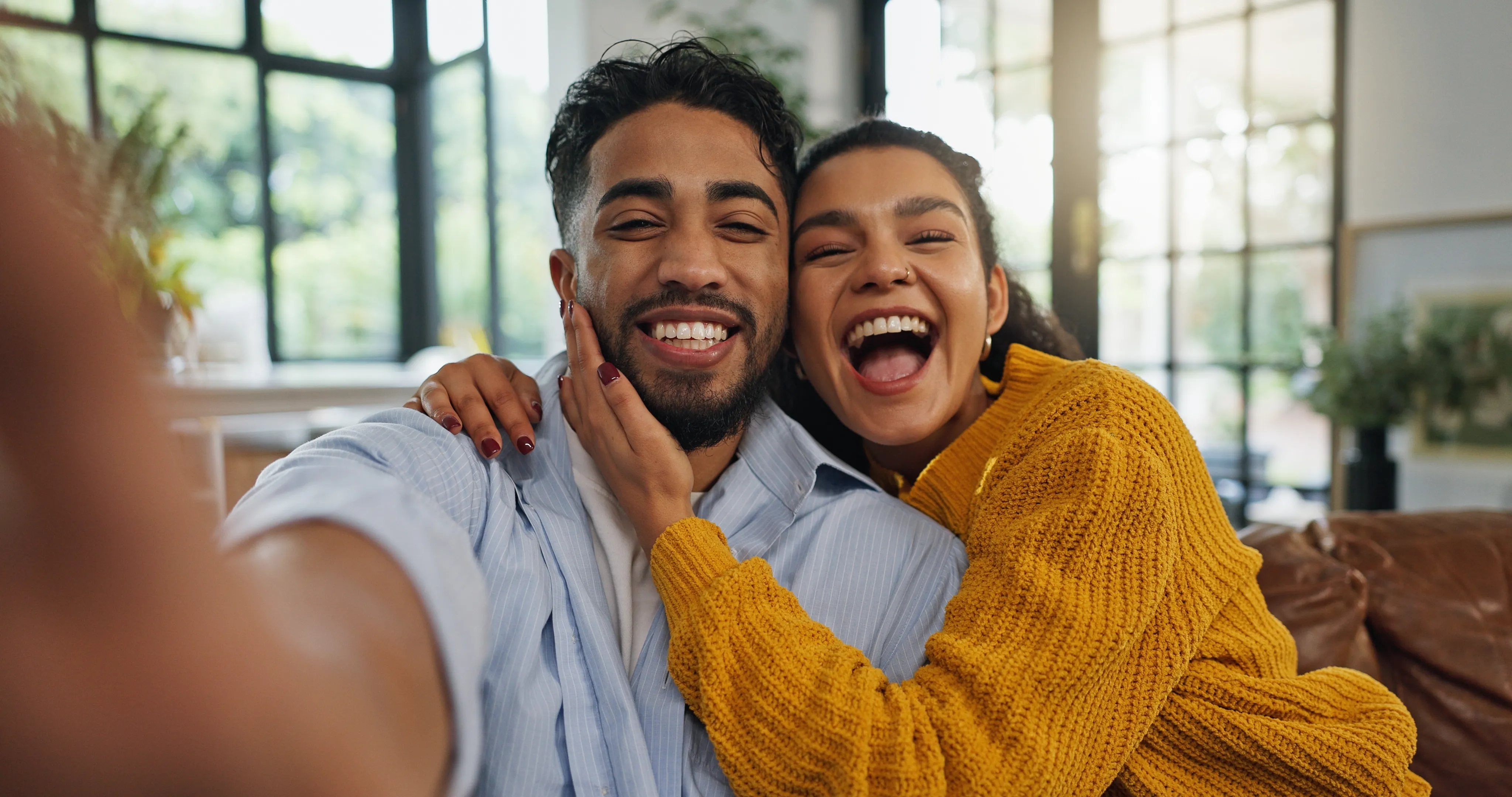 A couple smiling together at home